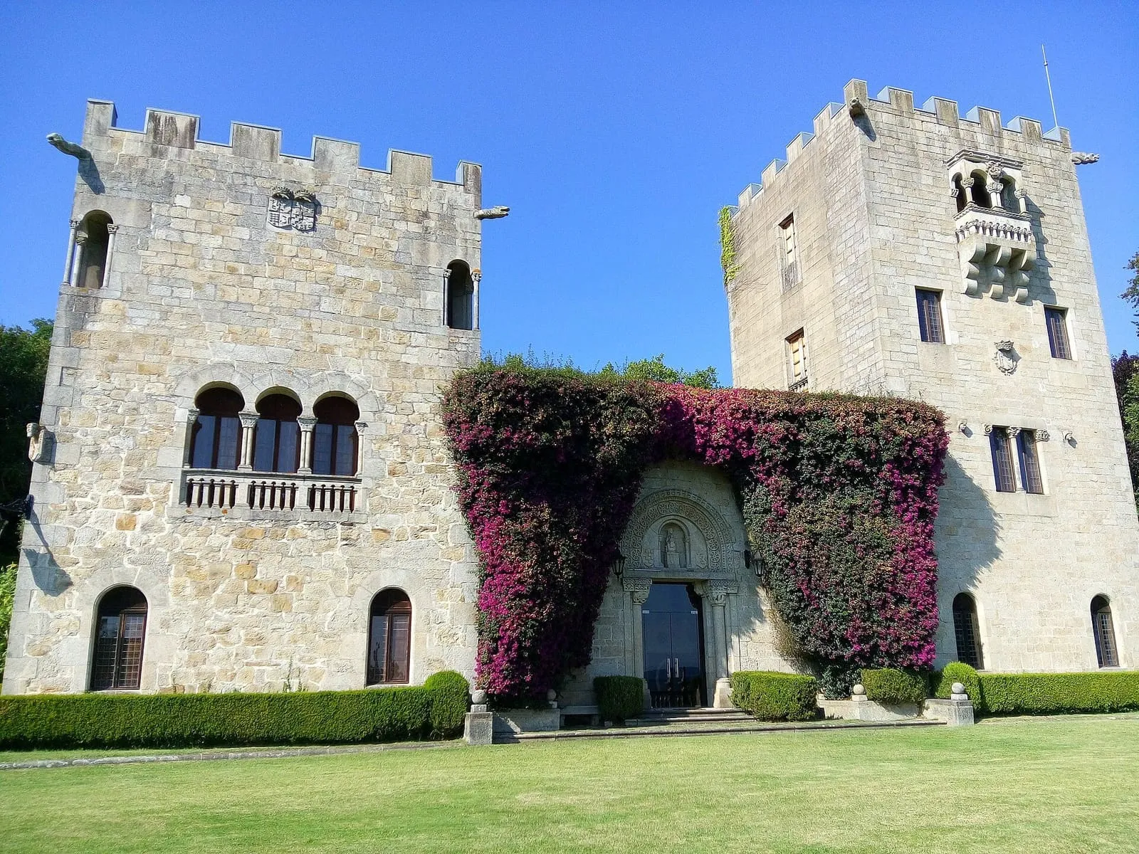 Torres almenadas del pazo de Meirás cubiertas de buganvilla