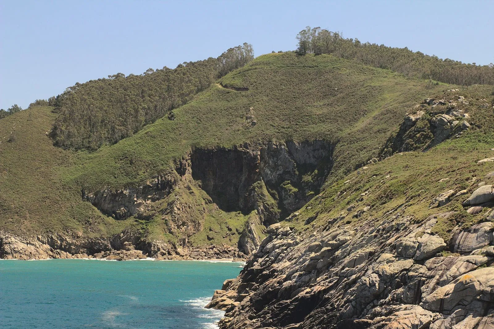 Costa verde y rocosa de Xove con una cala de aguas turquesa